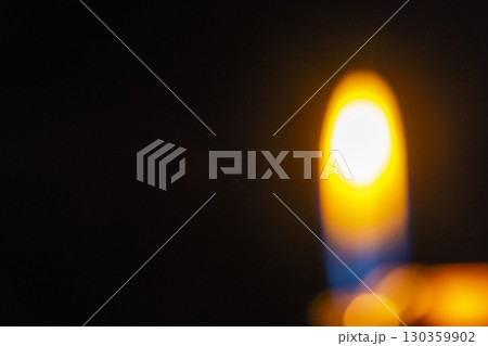 Abstract image showing blurred golden light with bokeh spheres against a dark background, creating a dreamy and atmospheric effect. Decorative element suitable for use as a background 130359902