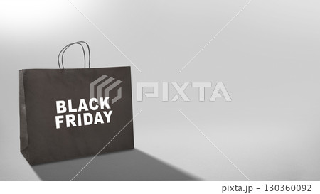 Closeup view of Black Friday text on a black shopping bag. Copy space. Flat lay. Black Friday sale concept Closeup view of Black Friday text on a black shopping bag. Copy space. Flat lay. Black Friday sale concept 130360092
