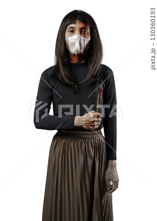 Indonesian southeast asian man dressed as a woman wearing a bloody face mask and holding a bloody knife isolated over a white background. Concept of Halloween, Sister Hong, or red uncle 130360193