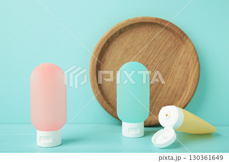 Travel bottles with body care cosmetics on blue background 130361649