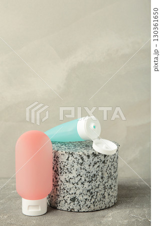 Cosmetic bottle on grey concrete background. Space for text Cosmetic bottle on grey concrete background. Space for text 130361650