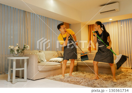 Dancing While Cleaning Couples Have Fun Enjoying Housework Together in Harmony 130361734
