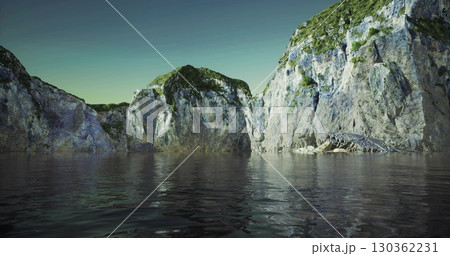 Rocky cliffs tower over smooth water, creating a serene atmosphere at twilight. The landscape features lush greenery and a tranquil sea, inviting peaceful contemplation. 130362231