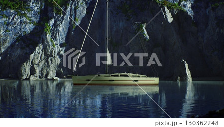 A sailing boat is anchored quietly in serene, reflective waters surrounded by towering rocky cliffs. The sunlight highlights the boat against the natural landscape. A sailing boat is anchored quietly in serene, reflective waters surrounded by towering rocky cliffs. The sunlight highlights the boat against the natural landscape. 130362248