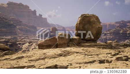 Vast desert terrain features unique rock formations under a bright blue sky. The scene captures the rough, natural beauty of an arid landscape with scattered boulders. Vast desert terrain features unique rock formations under a bright blue sky. The scene captures the rough, natural beauty of an arid landscape with scattered boulders. 130362280