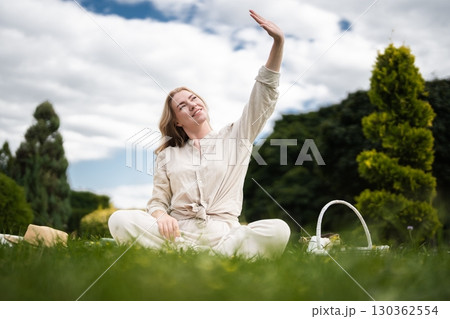 Embracing sunshine and relaxation during an outdoor picnic gathering Embracing sunshine and relaxation during an outdoor picnic gathering 130362554