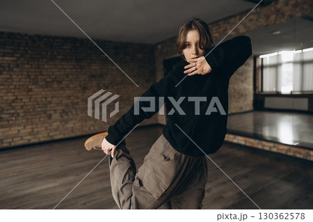 Dynamic dance rehearsal in modern studio setting with expressive movement 130362578