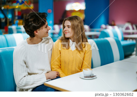 Couples share joyful moments in colorful cafe during a cozy afternoon Couples share joyful moments in colorful cafe during a cozy afternoon 130362602