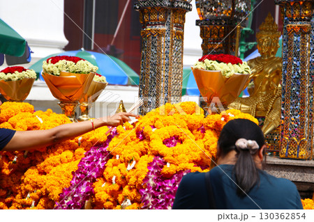 Marigold flower garlands offered for worship at the Erawan Shrine in Bangkok, Thailand. Marigold flower garlands offered for worship at the Erawan Shrine in Bangkok, Thailand. 130362854
