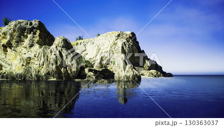 A stunning rocky cliff stands majestically over calm waters, illuminated by the soft light of dawn. The scene captures natures beauty, with the peaceful expanse inviting reflection and serenity. A stunning rocky cliff stands majestically over calm waters, illuminated by the soft light of dawn. The scene captures natures beauty, with the peaceful expanse inviting reflection and serenity. 130363037