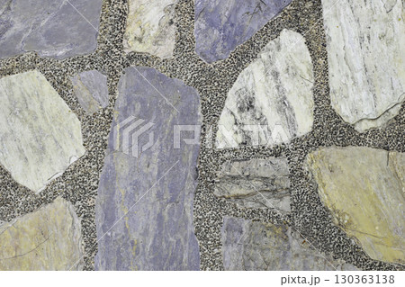 Decorative stone pavement with irregularly shaped natural rocks set in concrete. Decorative stone pavement with irregularly shaped natural rocks set in concrete. 130363138
