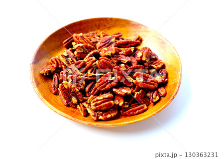 Delicious salted pecan nuts scattered. 130363231