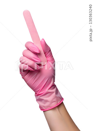 Pink gloved hand holding nail file, close-up view of professional manicure tool isolated on transparent background 130363240