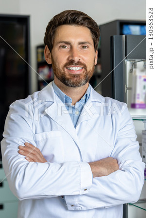 Caucasian male pharmacist in a lab coat at his working place Caucasian male pharmacist in a lab coat at his working place 130363528