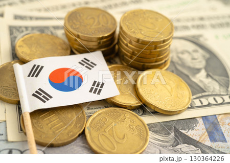 South Korea flag on coin and banknote money, finance trading investment business currency. South Korea flag on coin and banknote money, finance trading investment business currency. 130364226
