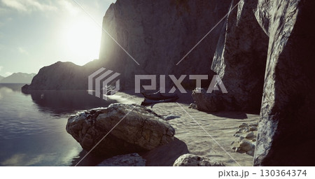 The sun sets behind rocky cliffs, casting a warm glow over a tranquil beach. Small boats rest on the shore, while gentle waves lap at the sand. The atmosphere is peaceful and inviting. The sun sets behind rocky cliffs, casting a warm glow over a tranquil beach. Small boats rest on the shore, while gentle waves lap at the sand. The atmosphere is peaceful and inviting. 130364374