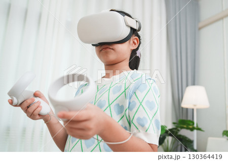 Girl Using Virtual Reality Headset for Learning and Entertainment 130364419
