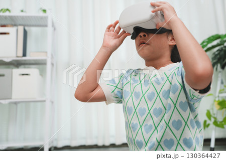 Child looking up in awe at metaverse. Future of digital exploration. 130364427