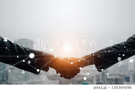 握手するビジネスパーソンとデジタルネットワークのコンセプト 130364896