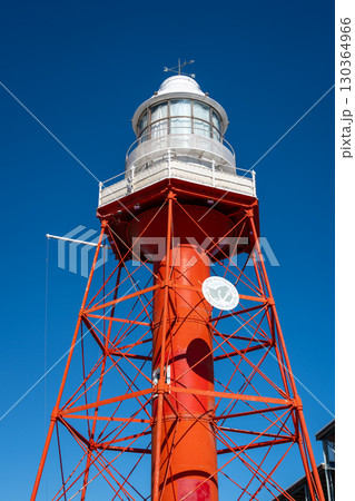 Red lighthouse with metal structure under blue sky in Adelaide, Australia 130364966