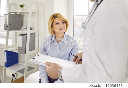 Doctor therapist consulting female patient in medical clinic Doctor therapist consulting female patient in medical clinic 130365284