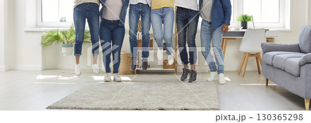 Banner with a cropped shot of a group of happy young friends jumping all together 130365298