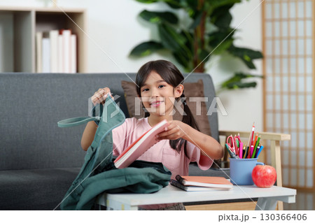 Back to School. Girl packing her backpack with notebooks and stationery. 130366406