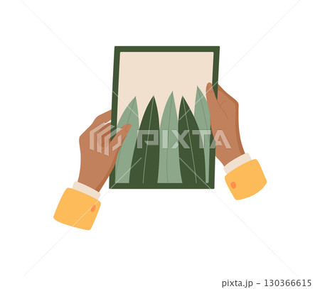 Hand holding a flat paper note card with flower design and envelope. Concept of love and handmade stationery, creative communication, suitable for holiday or romantic occasions. 130366615