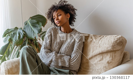 Pensive Woman Relaxing on Cozy Sofa at Home 130368117