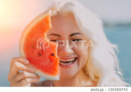 Watermelon Woman Summer: Beach Fun, joyful woman playfully holds a watermelon slice, summer outdoor portrait. 130369743