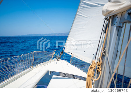 Bow of a sailing yacht cutting through the sea with sails fully open near Croatia. Freedom, motion, clean energy and slow travel on the open water. 130369748