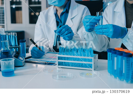 Collaboration, tablet or science with people in lab together for research or development. Innovation, tech and microscope with scientist team in clinical trial for planning or medical investigation 130370619