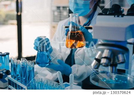 Collaboration, tablet or science with people in lab together for research or development. Innovation, tech and microscope with scientist team in clinical trial for planning or medical investigation 130370624