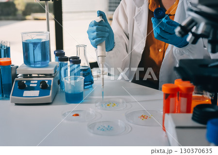 Collaboration, tablet or science with people in lab together for research or development. Innovation, tech and microscope with scientist team in clinical trial for planning or medical investigation 130370635