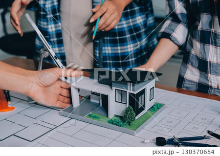 Construction and structure concept of engineer working drawing on blueprint meeting for project working with partner on model building and engineering tools in working site, construction concept. Construction and structure concept of engineer working drawing on blueprint meeting for project working with partner on model building and engineering tools in working site, construction concept. 130370684
