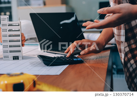 Construction and structure concept of engineer working drawing on blueprint meeting for project working with partner on model building and engineering tools in working site, construction concept. 130370714