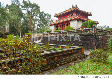 Ancient pavilion at Minh Mang Tomb surrounded by tiered walls and lush gardens in Hue, Vietnam Ancient pavilion at Minh Mang Tomb surrounded by tiered walls and lush gardens in Hue, Vietnam 130370771