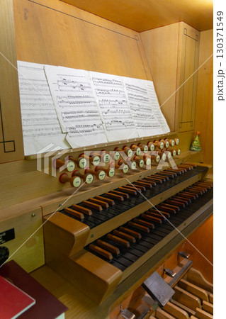 Antique organ keyboard and controls in a Lutheran church. Antique organ keyboard and controls in a Lutheran church. 130371549