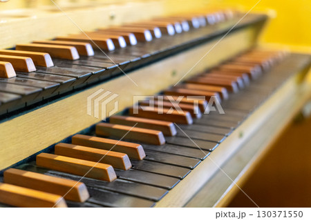 Antique organ keyboard and controls in a Lutheran church. Antique organ keyboard and controls in a Lutheran church. 130371550