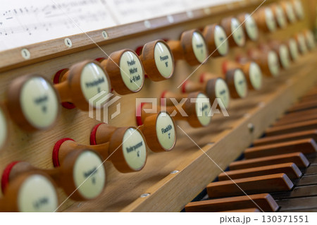 Antique organ keyboard and controls in a Lutheran church. Antique organ keyboard and controls in a Lutheran church. 130371551