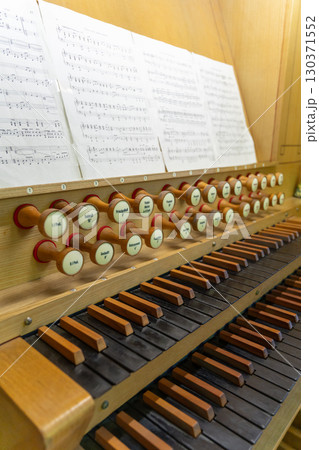 Antique organ keyboard and controls in a Lutheran church. Antique organ keyboard and controls in a Lutheran church. 130371552