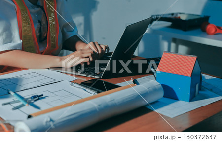 Closeup of team of industrial engineers meeting analyze machinery blueprints consult project on table in manufacturing factory. Working in manufacturing plant or production plant. Closeup of team of industrial engineers meeting analyze machinery blueprints consult project on table in manufacturing factory. Working in manufacturing plant or production plant. 130372637