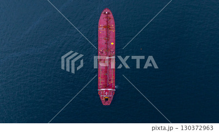 Aerial view crude oil tanker ship at sea, Red crude oil tanker ship top view, Logistic and maritime transpoprtation of petroleum, Modern offshore terminal  loading tanker ship. 130372963