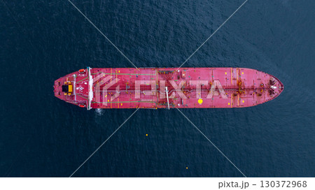 Aerial view crude oil tanker ship at sea, Red crude oil tanker ship top view, Logistic and maritime transpoprtation of petroleum, Modern offshore terminal  loading tanker ship. 130372968