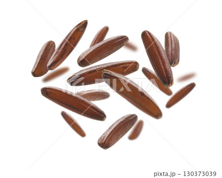 Raw brown rice levitates on a white background Raw brown rice levitates on a white background 130373039