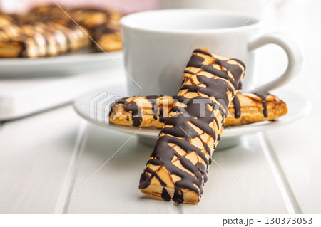 Sfogliatine glassate with chocolate. Italian crispy dessert on white table. 130373053