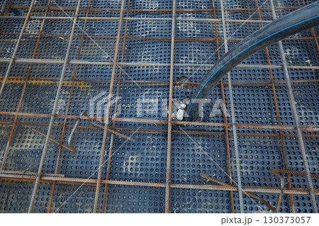 The construction of a concrete foundation using reinforcing steel prepared at the construction site The construction of a concrete foundation using reinforcing steel prepared at the construction site 130373057
