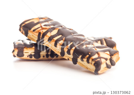Sfogliatine glassate with chocolate. Italian crispy dessert isolated on white background. 130373062