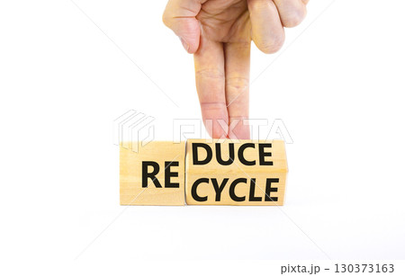 Reduce or recycle symbol. Concept words Reduce Recycle on wooden block. Beautiful white table white background. Businessman hand. Business reduce or recycle concept. Copy space. Reduce or recycle symbol. Concept words Reduce Recycle on wooden block. Beautiful white table white background. Businessman hand. Business reduce or recycle concept. Copy space. 130373163