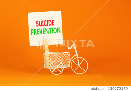Suicide prevention symbol. Concept words Suicide prevention on beautiful white paper on clothespin. Beautiful orange table orange background. Psychological and suicide prevention concept. Copy space. Suicide prevention symbol. Concept words Suicide prevention on beautiful white paper on clothespin. Beautiful orange table orange background. Psychological and suicide prevention concept. Copy space. 130373170